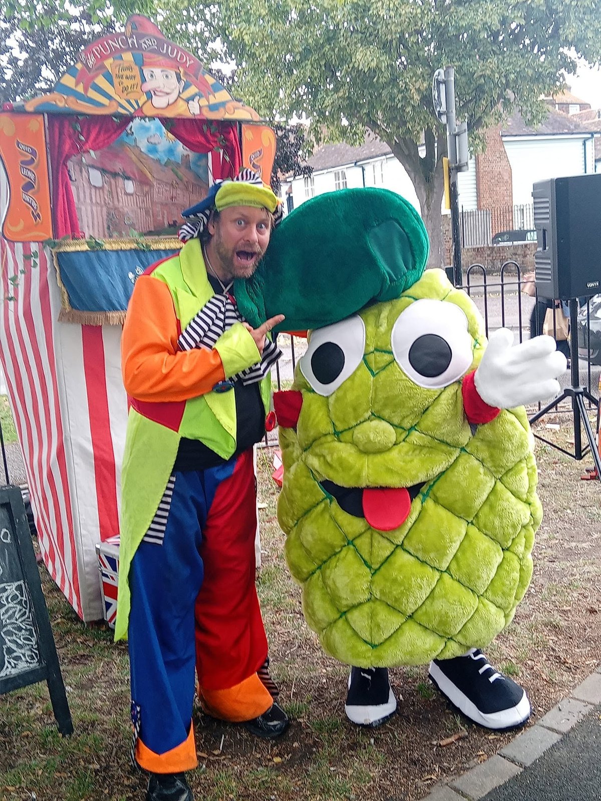 Magic Al with a colourful character at a family event